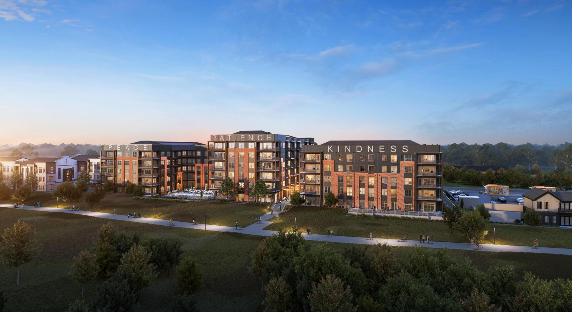 Modern apartment complex at dusk with lit windows, landscaped grounds, and a blue evening sky