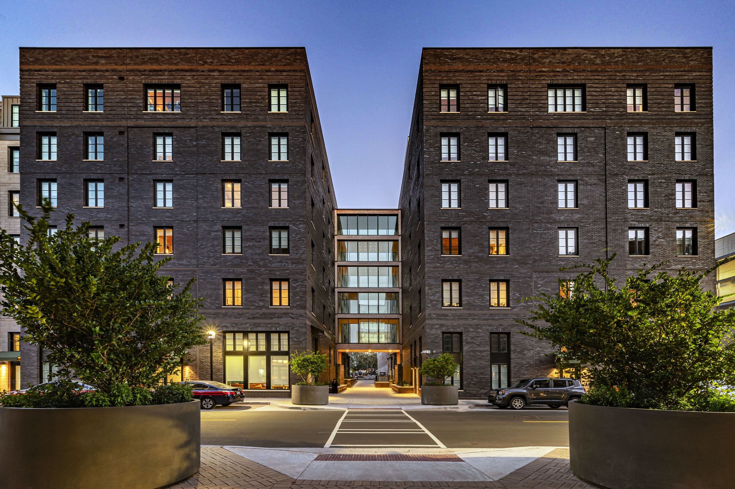 Street-facing exterior of The Ann Savannah, showing the two brick wings and the glazed connector across Ann Street.