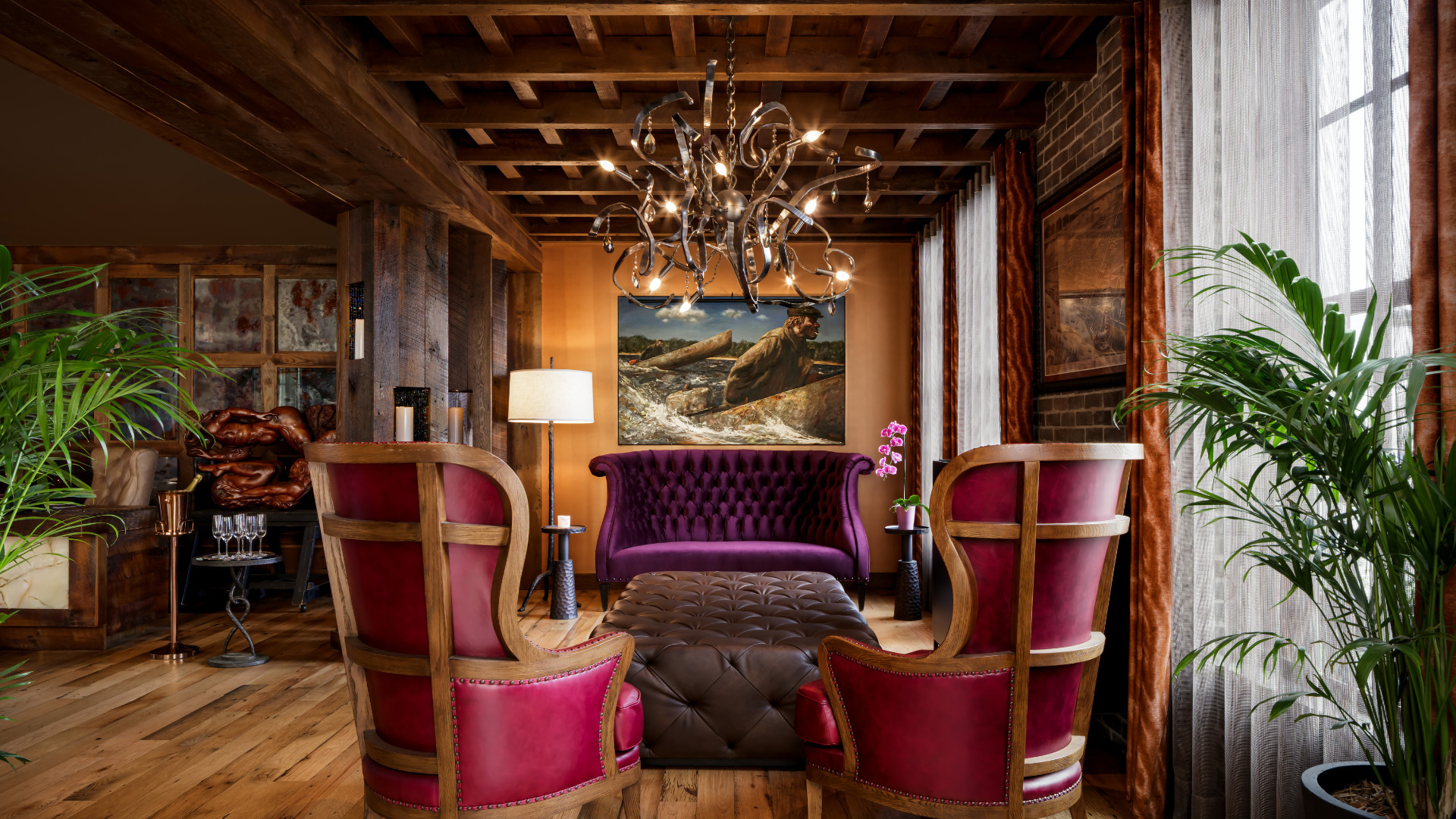 a room with purple furniture and a chandelier